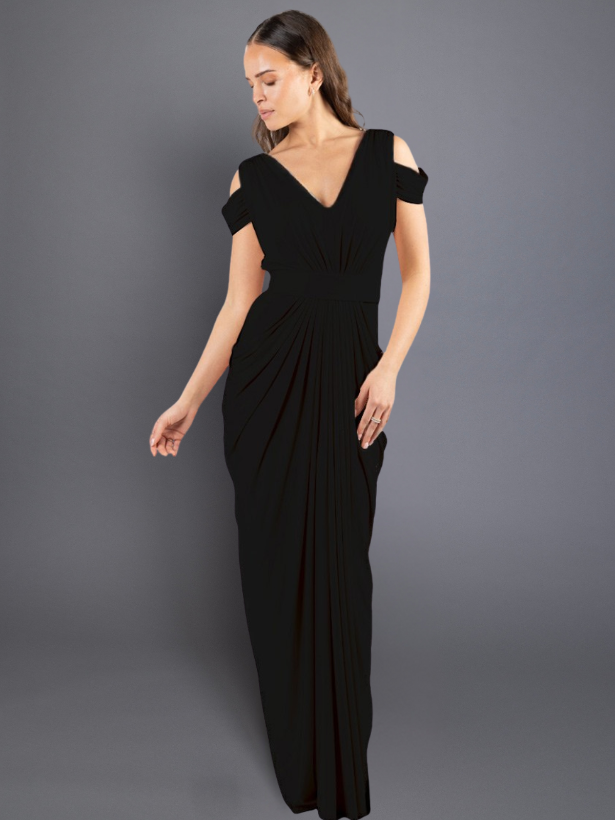 Woman wearing a black evening gown against a gray background