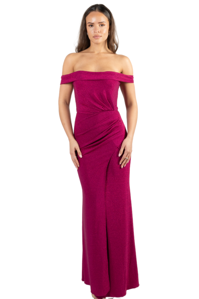 A woman wearing a red, off-the-shoulder, sweetheart neckline, draping on the hip and waist area with a curved slit, corseted top, and back zipper closure.